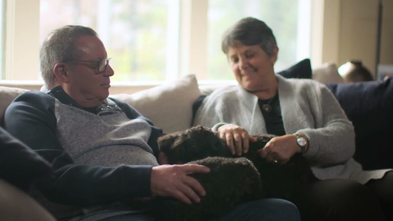 Man and women sitting on a couch sitting to each other